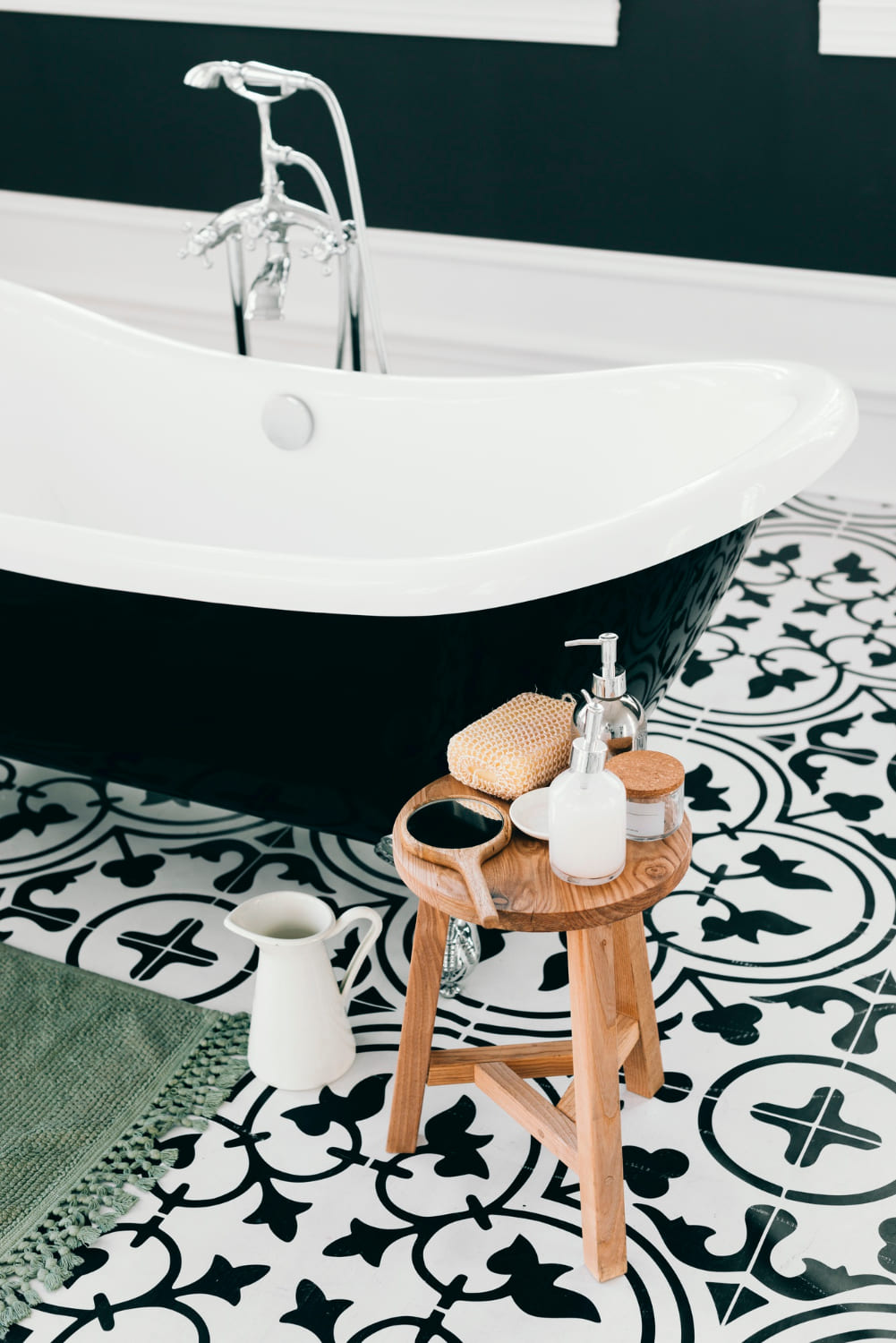 Black and white bathroom with bold tile pattern and wooden accents
